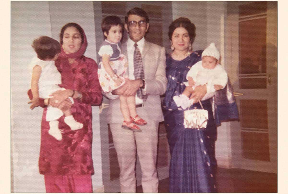 Picture from 1970 of a South Asian family holding young children.