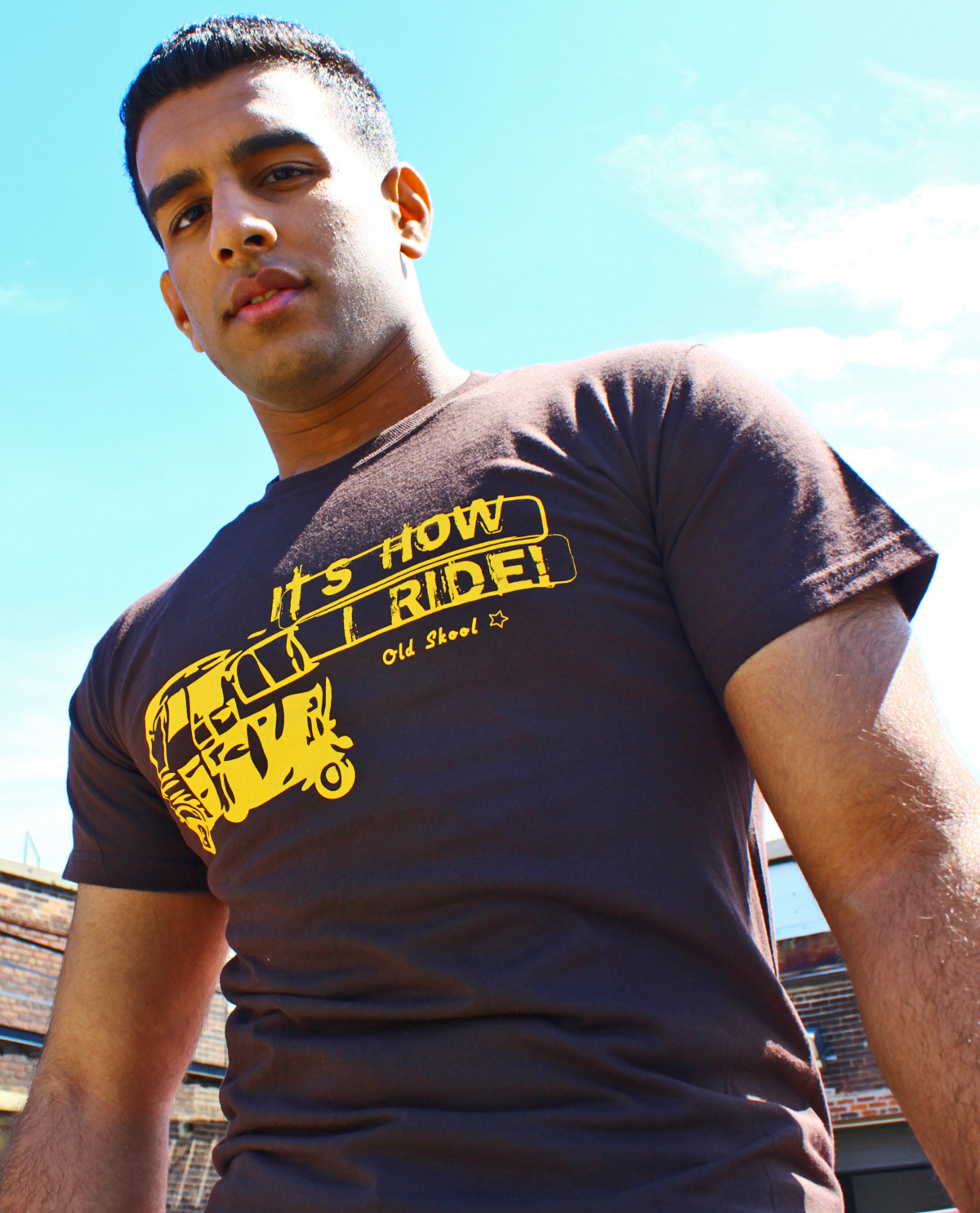 South Asian wearing graphic design t.shirt by Brown Man Clothing Co. It's How I Ride. Vintage image of rickshaw. Designed by Brown Man Clothing Co.