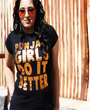 Female model wearing black fitted graphgic design tshirt with Punjabi Girls Do It Better written on the front in block lettering with copper foil design.